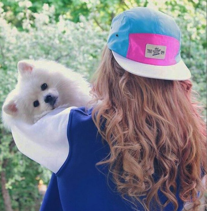 ילדה עם כלב בזרועותיה